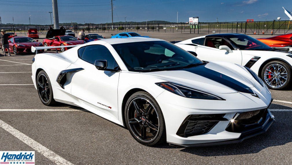 White Chevrolet Corvette displayed at a Hendrick Driven for Veterans automotive event