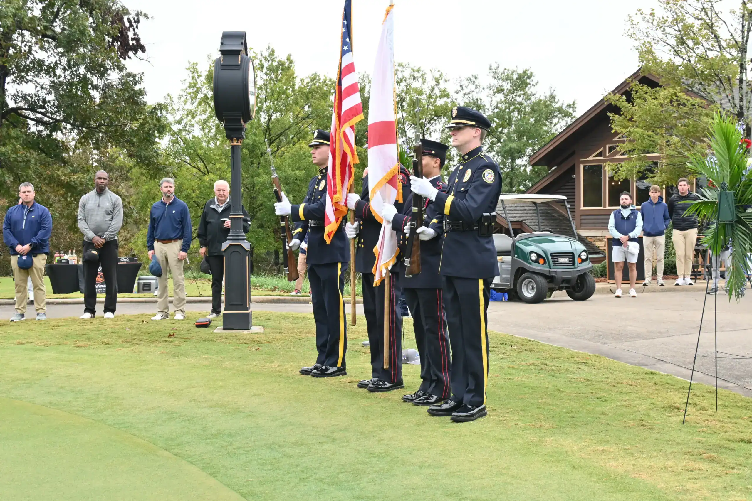 Uniformed color guard presents American flags at a veterans support event.